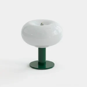 Macaron table lamp with white frosted glass shade and dark green metal base in modern minimalist style