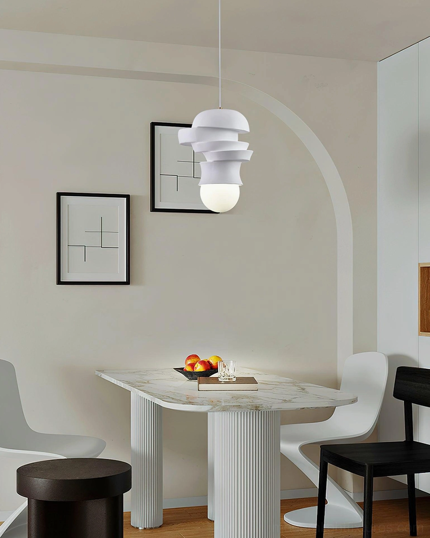Modern stacked disc pendant light with white matte finish and exposed spherical bulb, side interior view of minimalist dining area