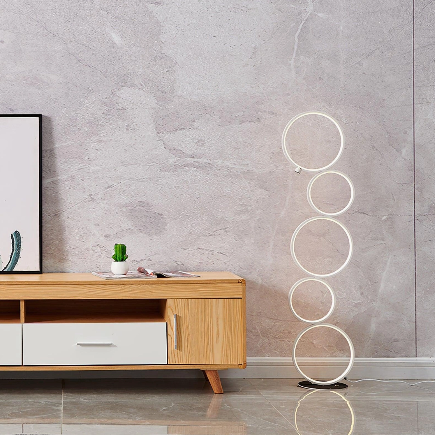 Modern minimalist white metal ring floor lamp beside wooden TV cabinet in contemporary living room