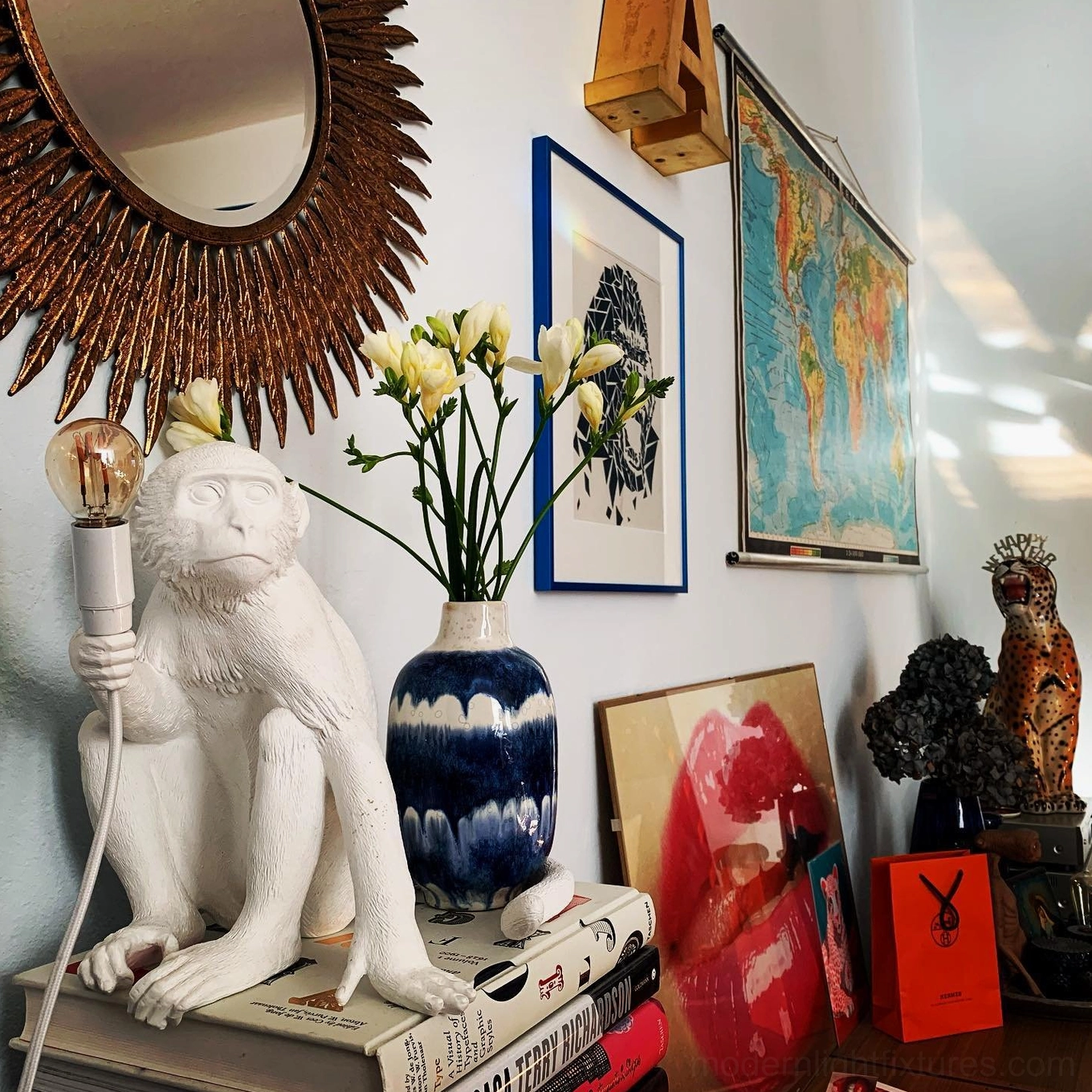 White monkey table lamp eye-level front view sitting monkey on stacked books