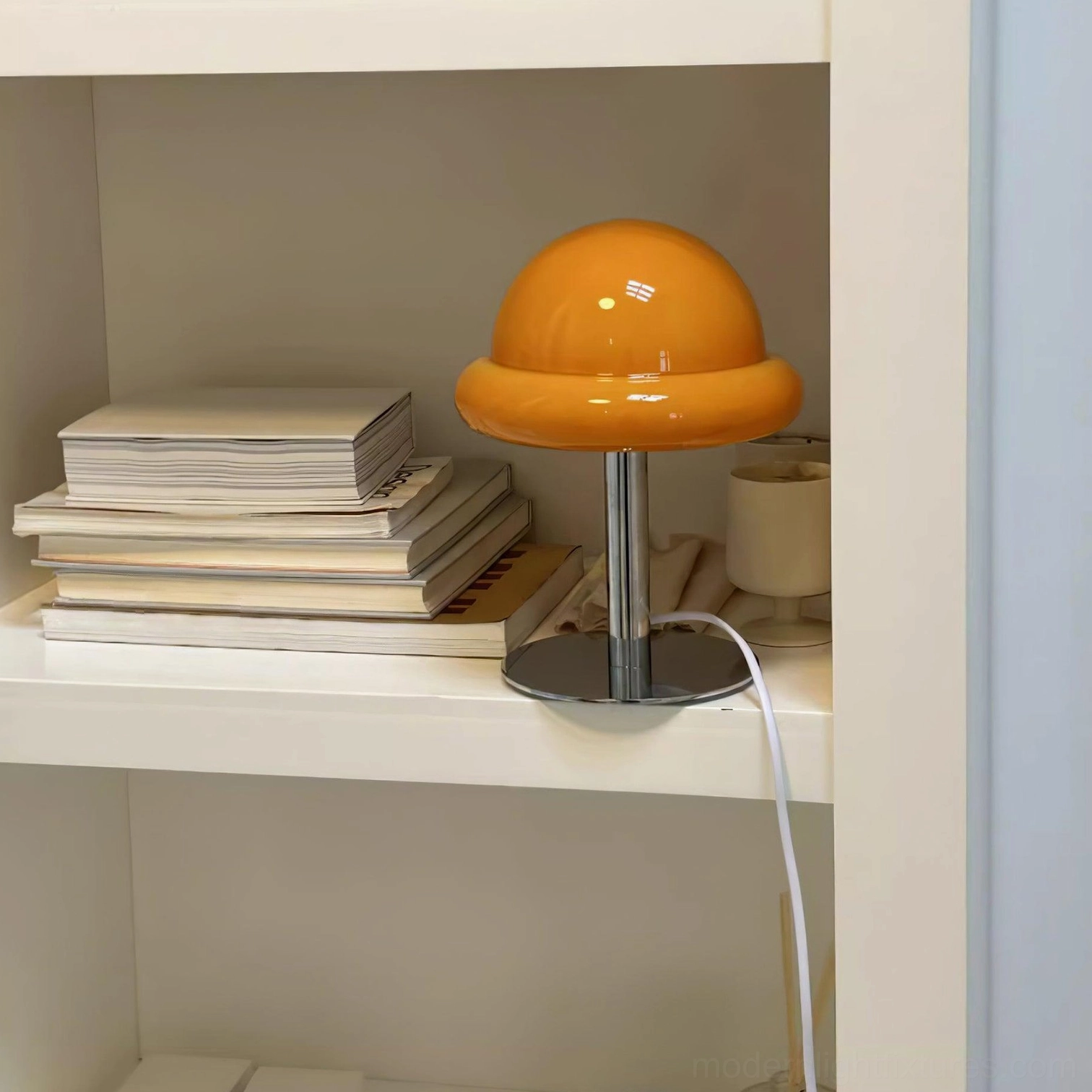 White mushroom glass table lamp providing task lighting on modern bedroom dresser
