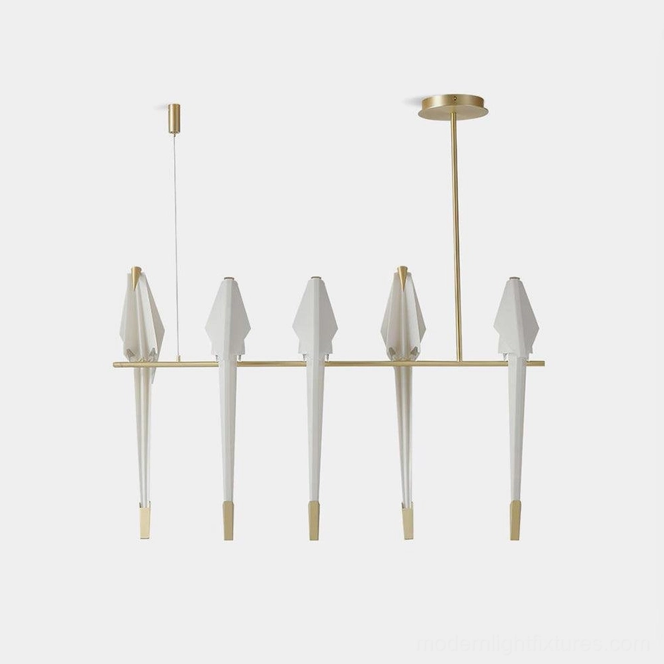Modern white origami crane chandelier with 5 brass heads on pure white background studio shot
