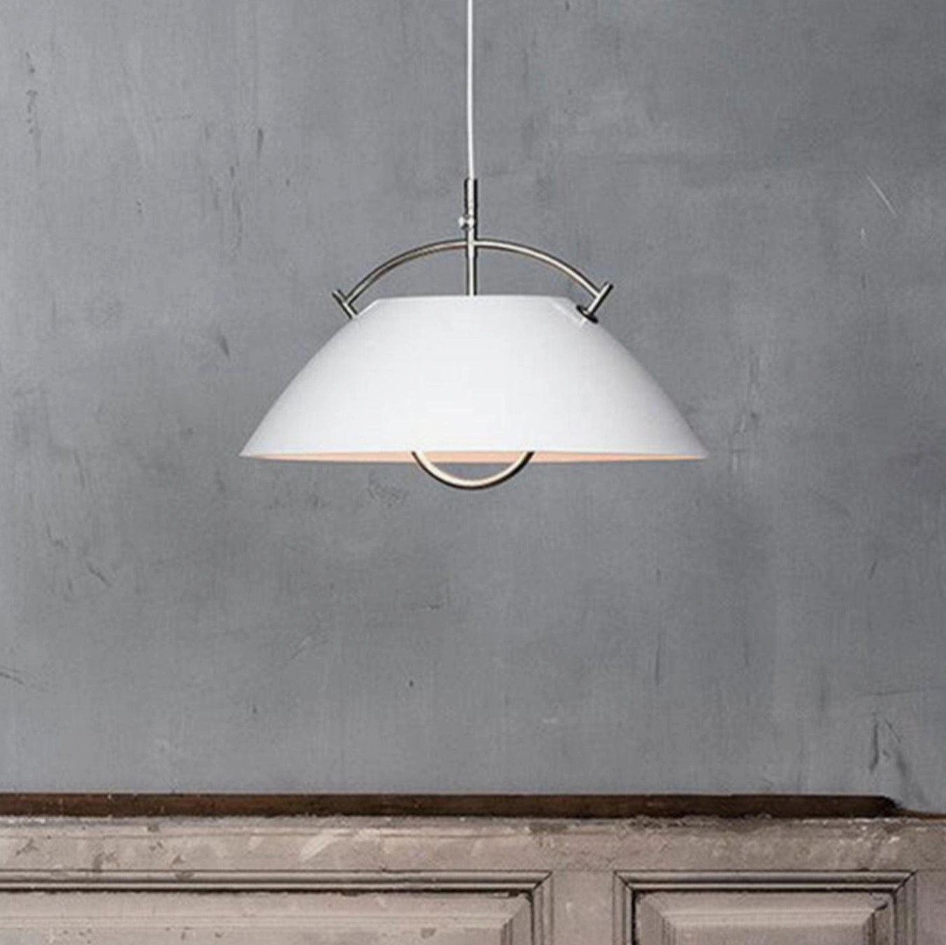 Matte white aluminum dome pendant light with polished silver hanging hardware, overhead angle