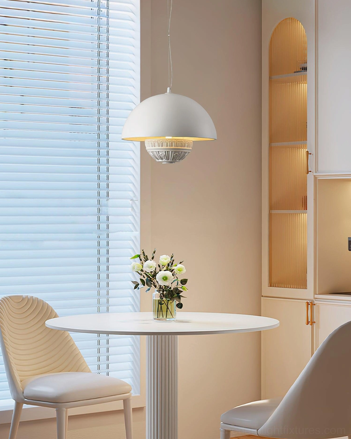 White dome pendant light side angle view above round dining table nook