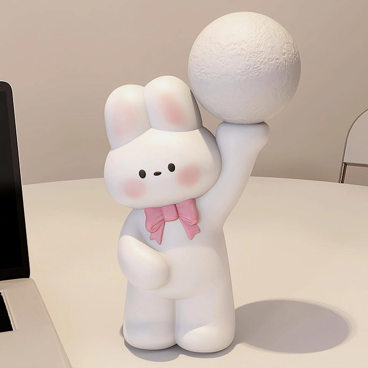 Cartoon rabbit desk lamp with matte white finish and pink bow - unlit moon lamp home office setting