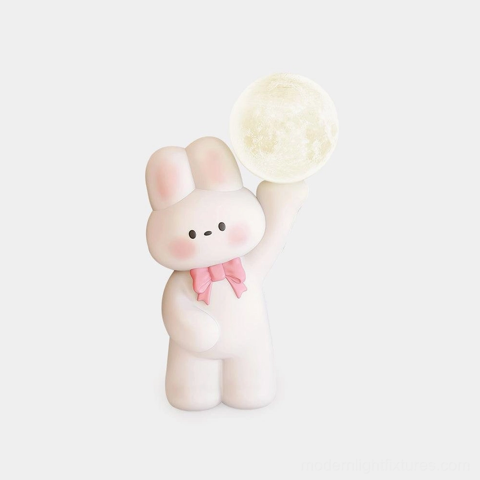 Cute white rabbit table lamp with pink bow tie on studio background - integrated LED moon lamp for modern home decor