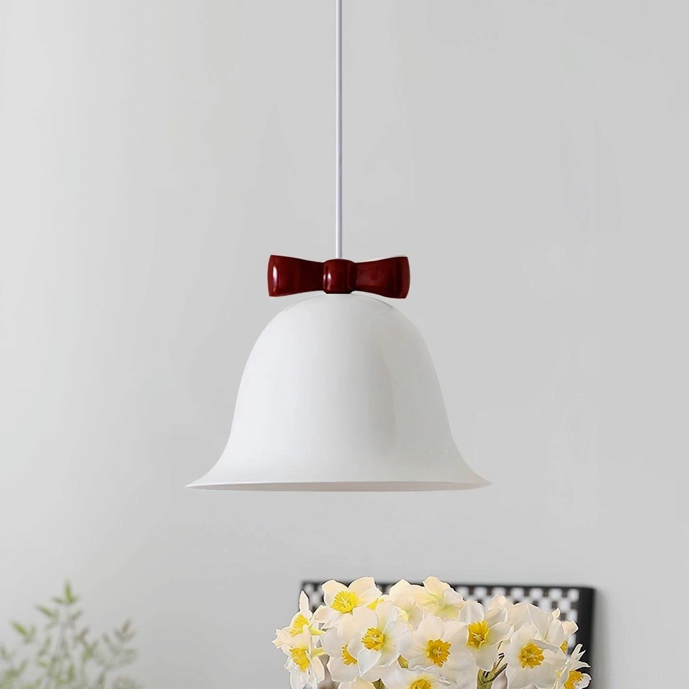 White and red two-tone ceramic bell pendant lamp with decorative bow on white background