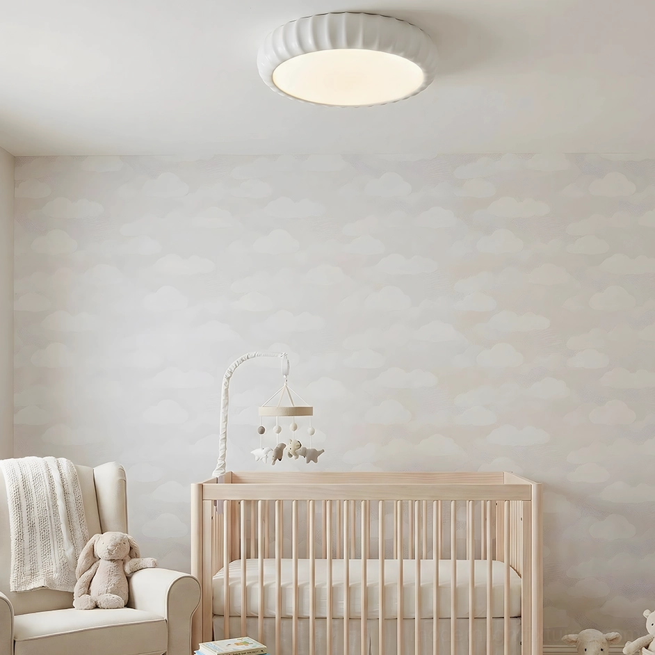 Off-white ceiling light fixture in baby nursery with cloud wall pattern - cozy muted decor