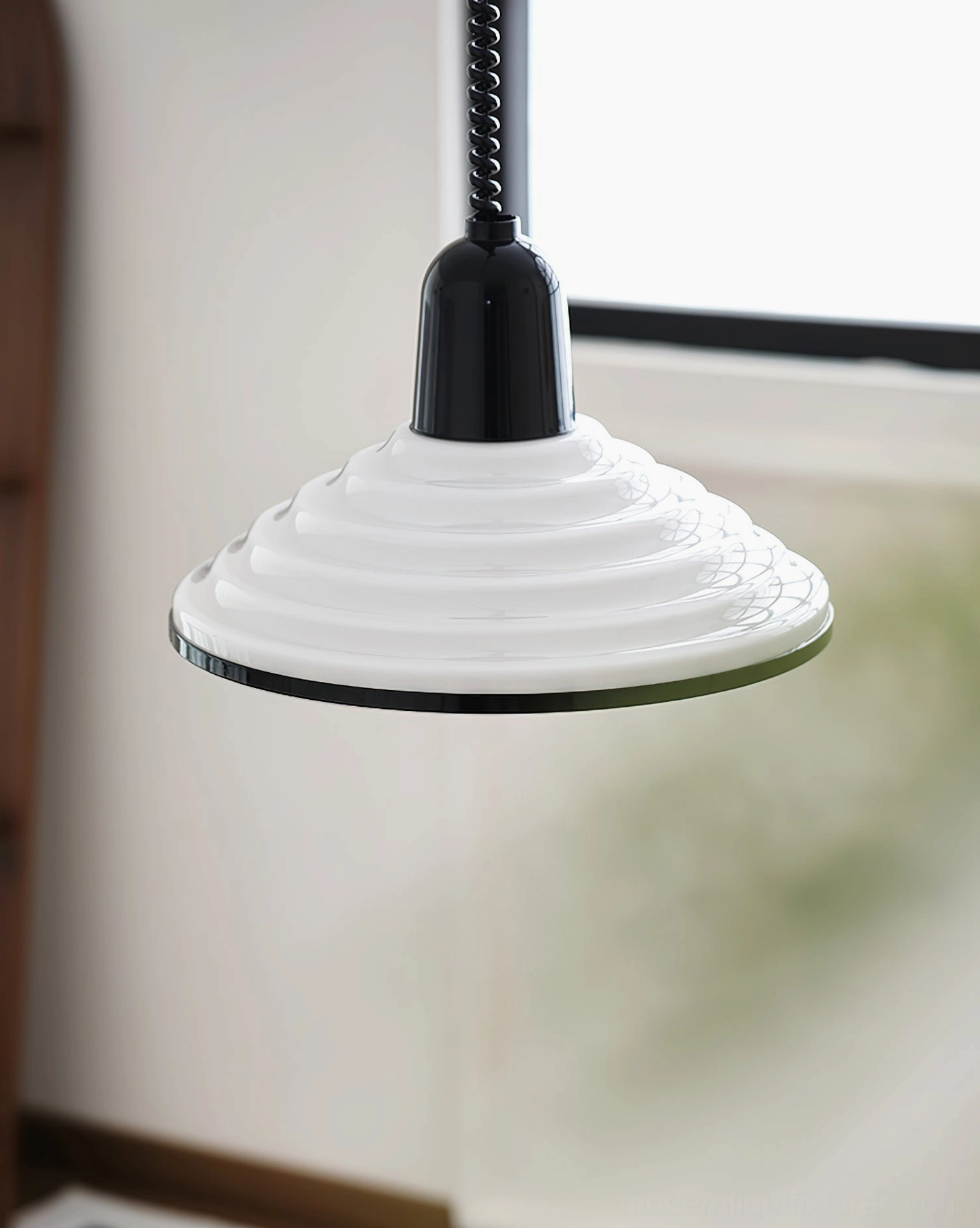 Left front view of white ribbed metal pendant light hanging in residential space with retro minimalist aesthetic