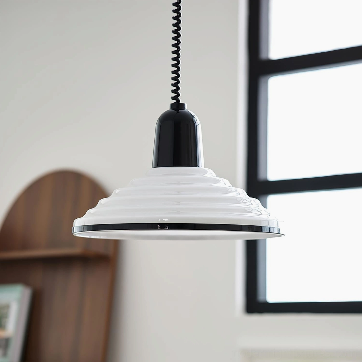 White ribbed pendant light hanging in minimalist residential interior with black-framed window, mid-century modern style
