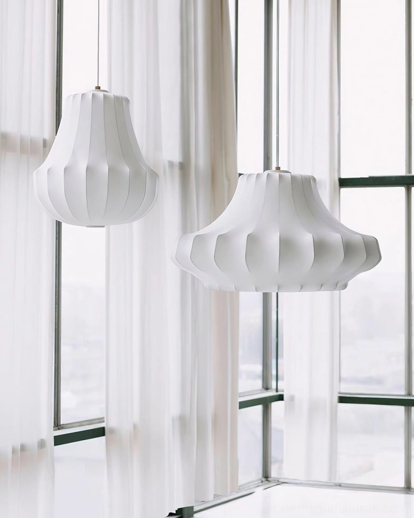 Teardrop ribbed white pendant light beside bright living room windows - side profile