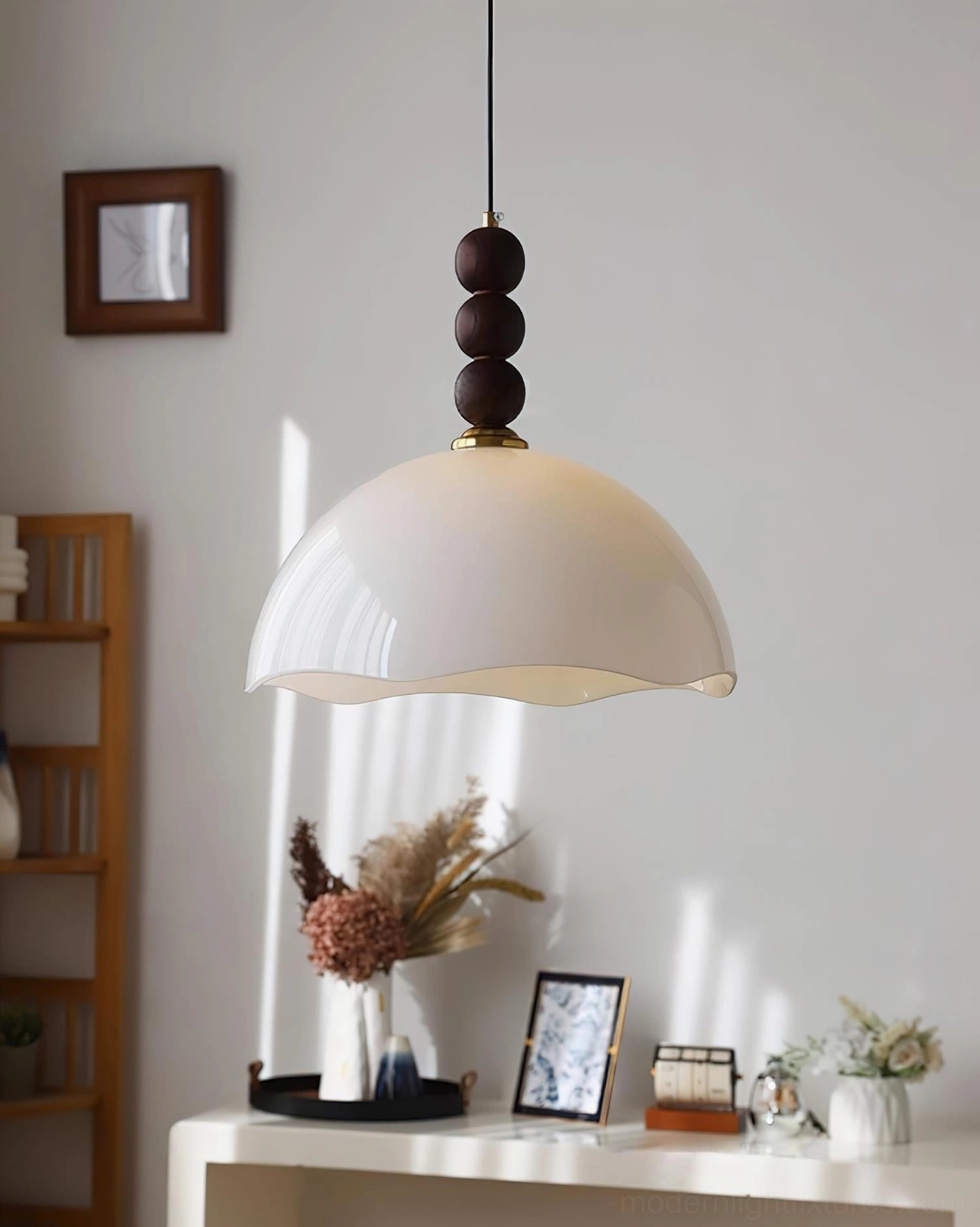 Side hanging view of pearl white rippled glass pendant light with dark wood bead finial in home entryway setting
