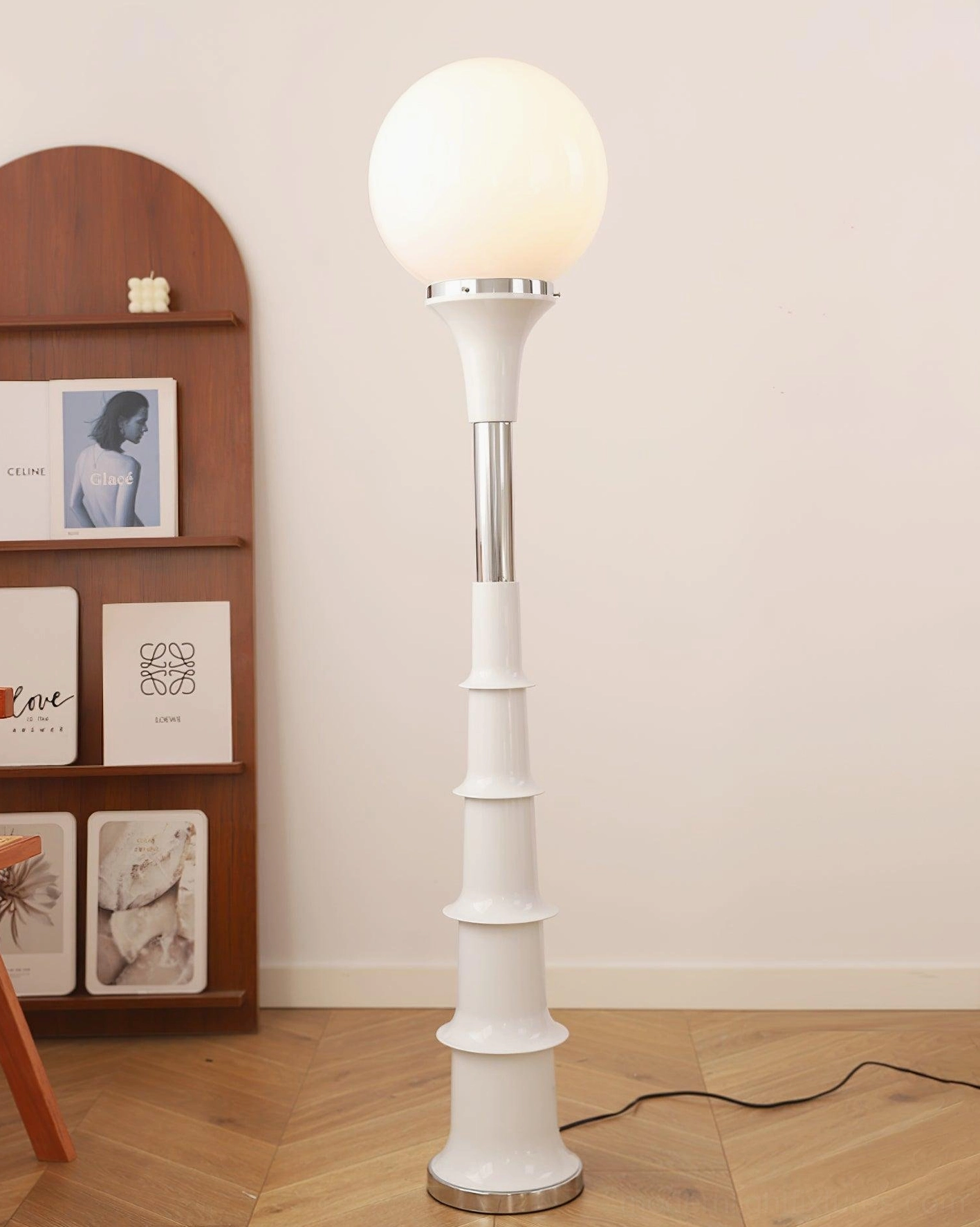 All-white segmented floor lamp with minimalist design and silver metal base in modern home setting
