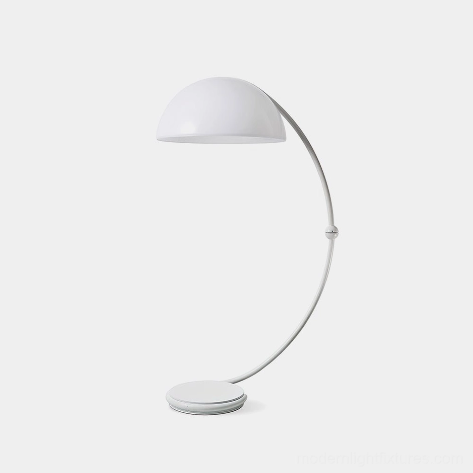 White Serpente articulated floor lamp with rotating dome shade in minimalist studio setting