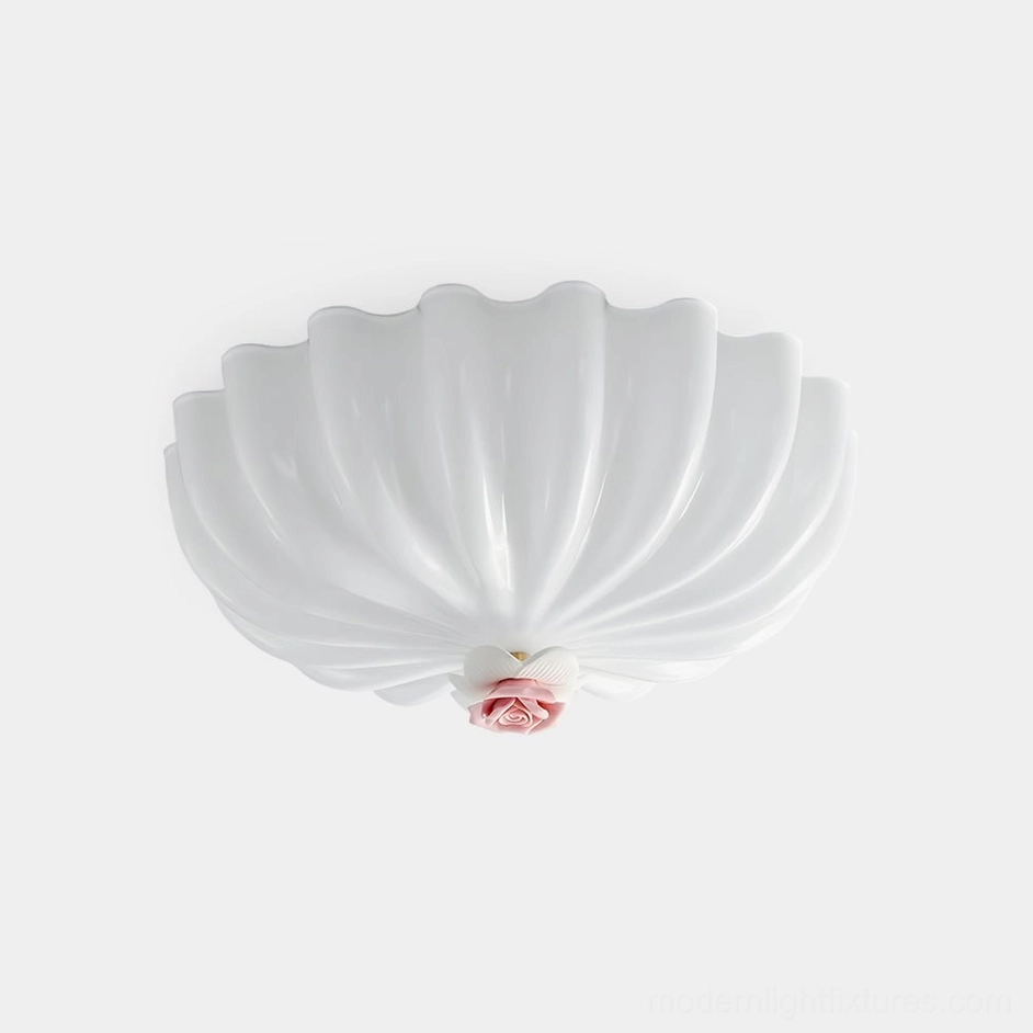 Belle Coquille white shell-shaped ceiling light fixture with pink rose accent detail, front view on plain studio background