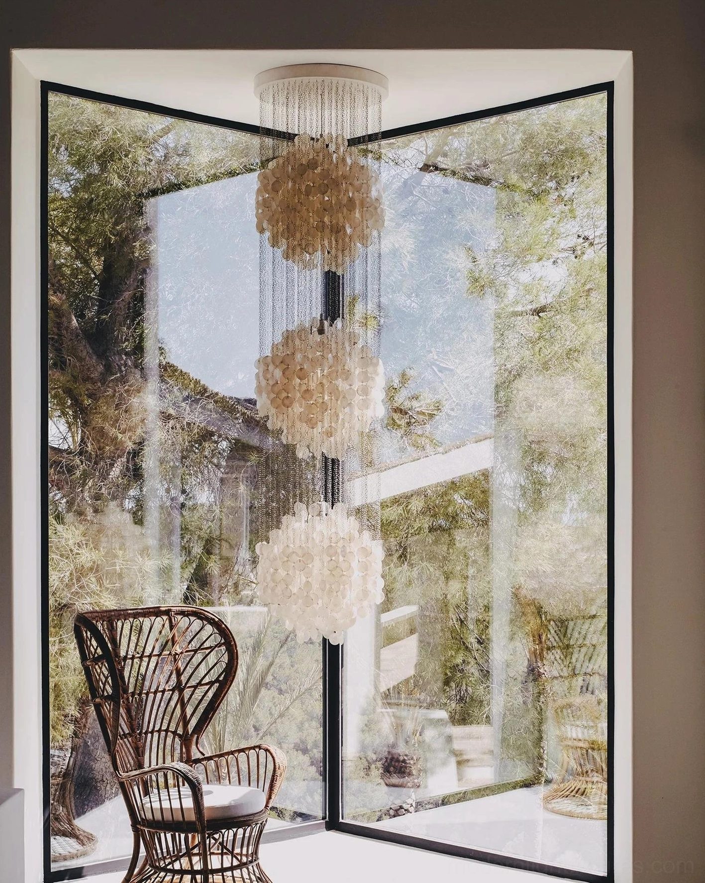Contemporary shell pendant light with pure white capiz clusters and metal suspension system side profile view