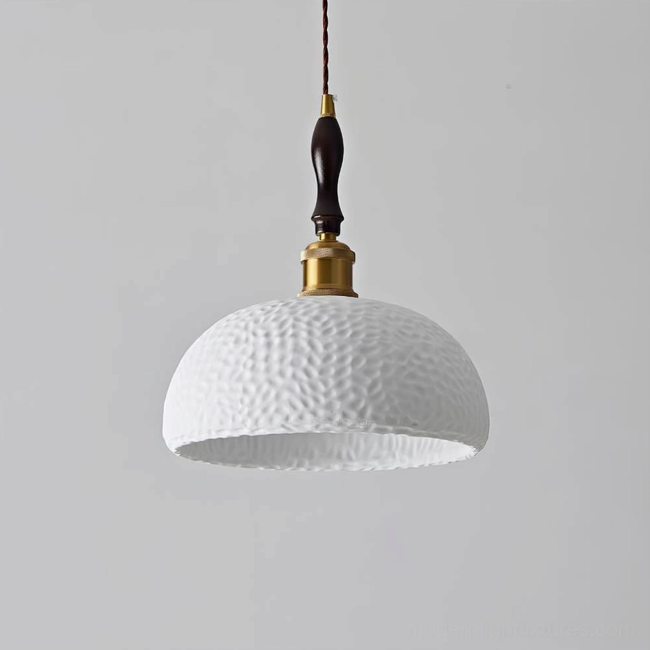White textured resin dome pendant light with brass and wood suspension components, front view