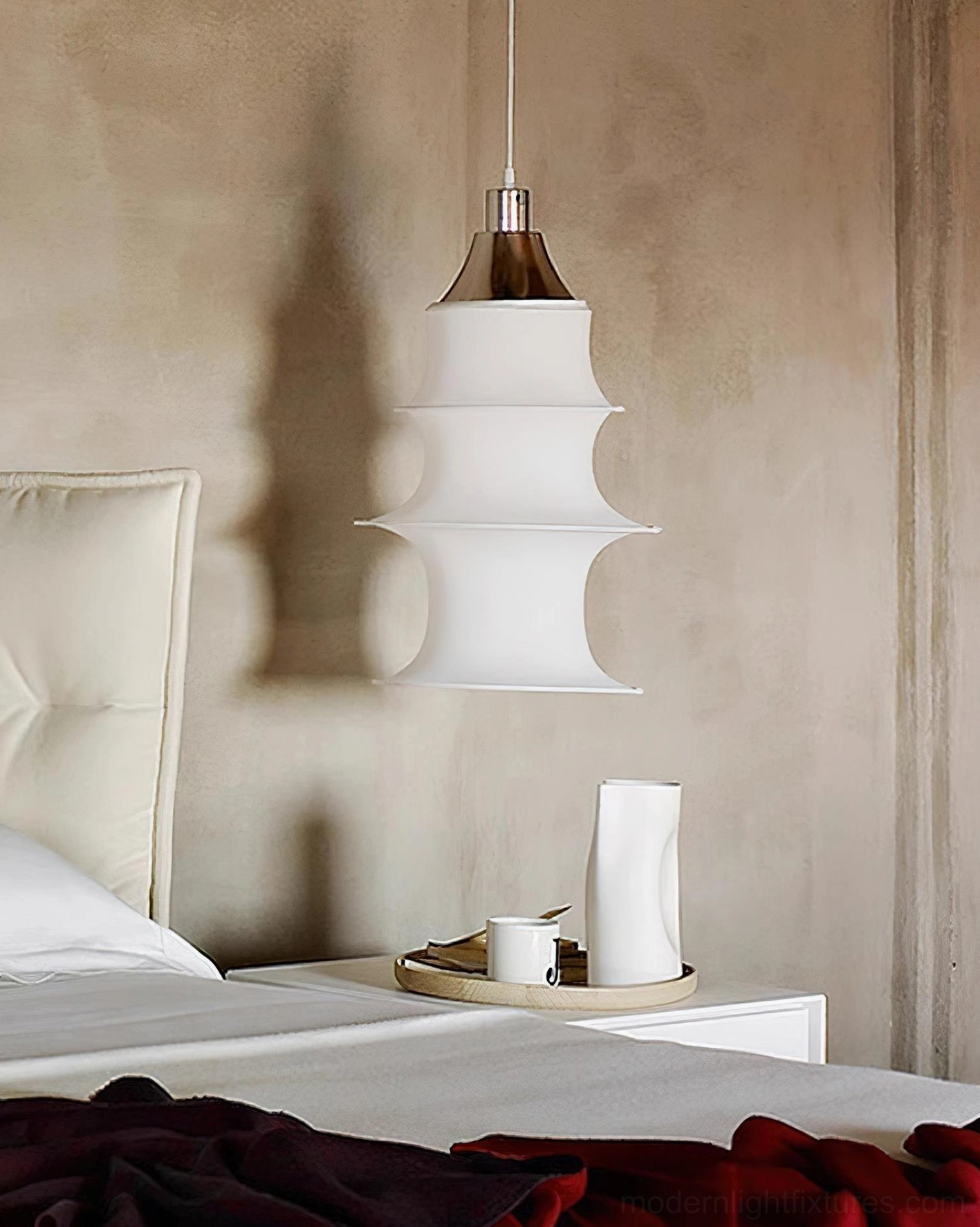 White tiered pendant lamp fixture detail showing tower-like stacked fabric layers