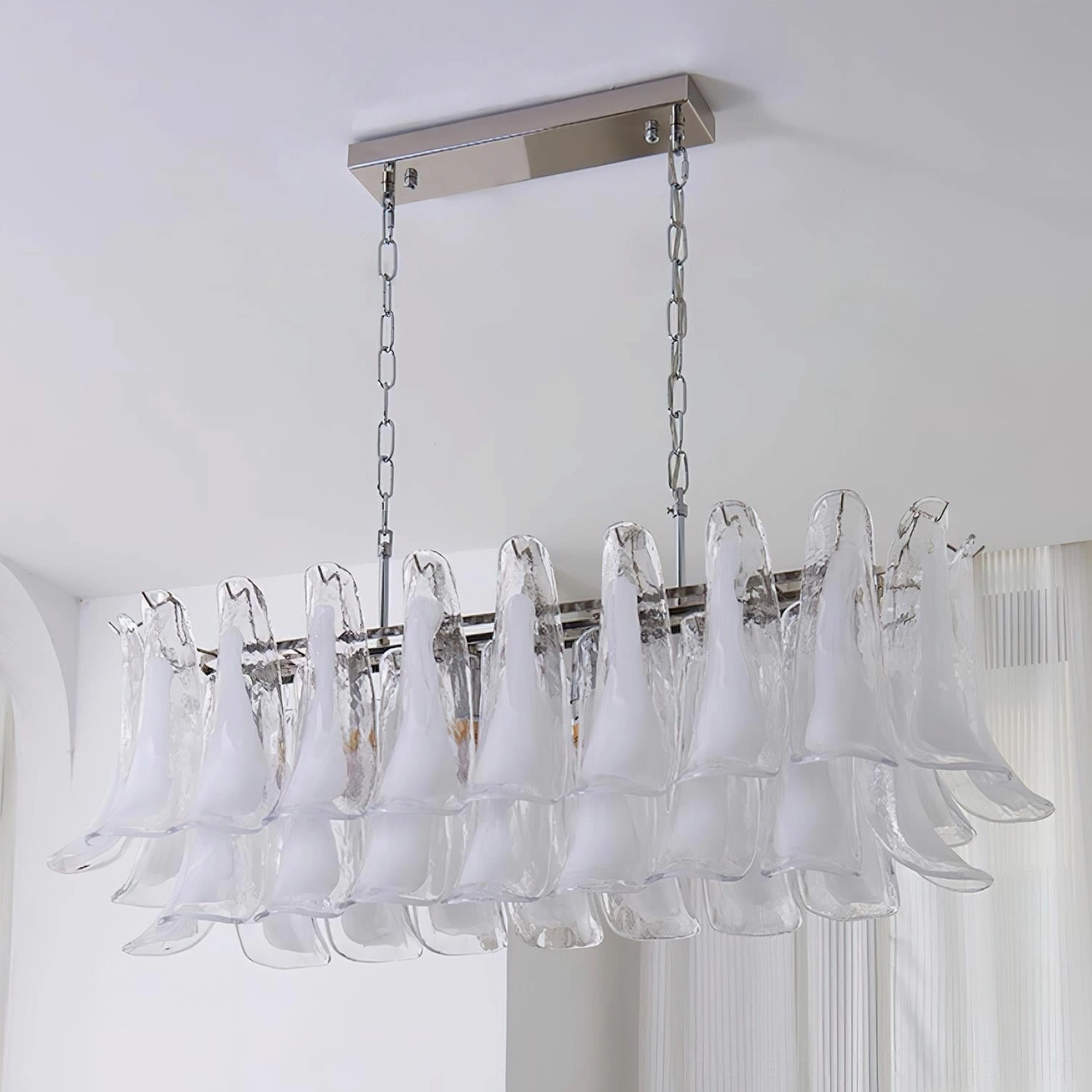 White frosted tulip leaf chandelier creating clean minimalist aesthetic in modern space