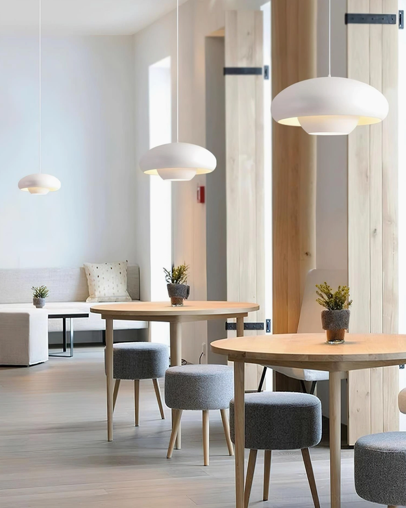 White Vario dome pendant lights in modern wooden dining space with minimalist stools and Nordic aesthetic
