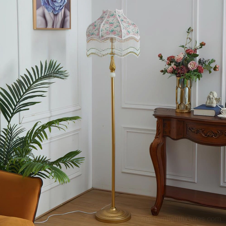 White Victorian floor lamp with scalloped floral shade and gold stand in classic interior
