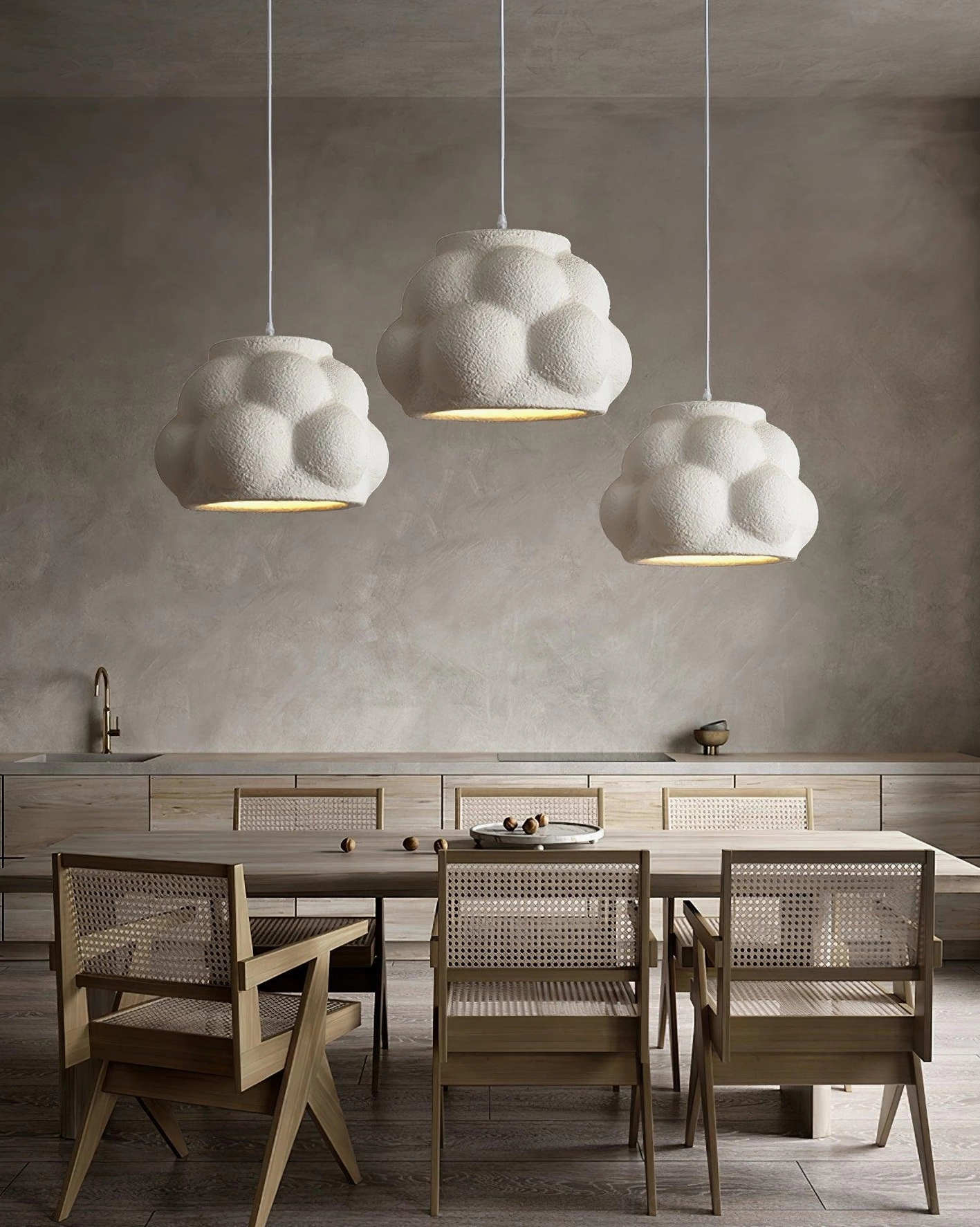 Multiple white organic pendant lights in contemporary dining room above rustic wooden table