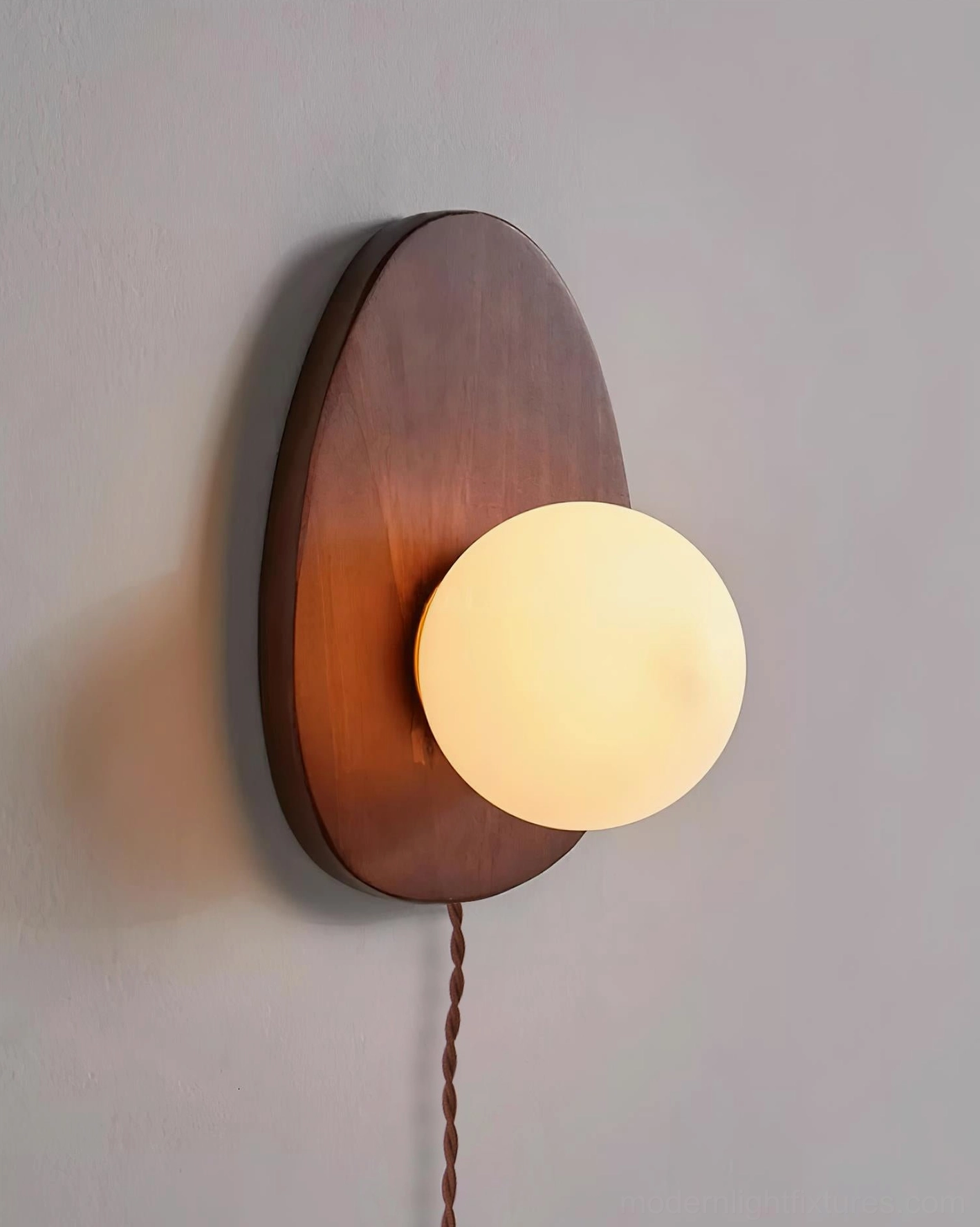 White finish plug-in wall sconce with frosted glass shade, contemporary minimalist bedroom styling