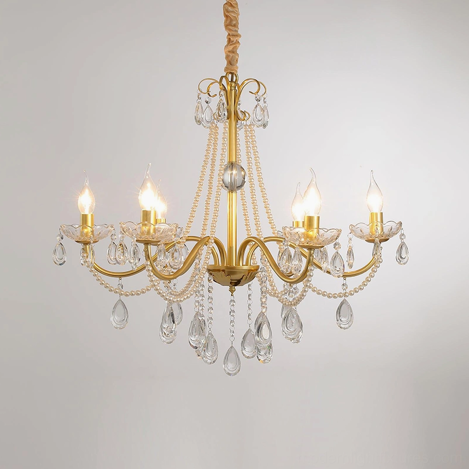 8-light gold crystal chandelier with central glass ornament and candle-style bulbs, studio product photography