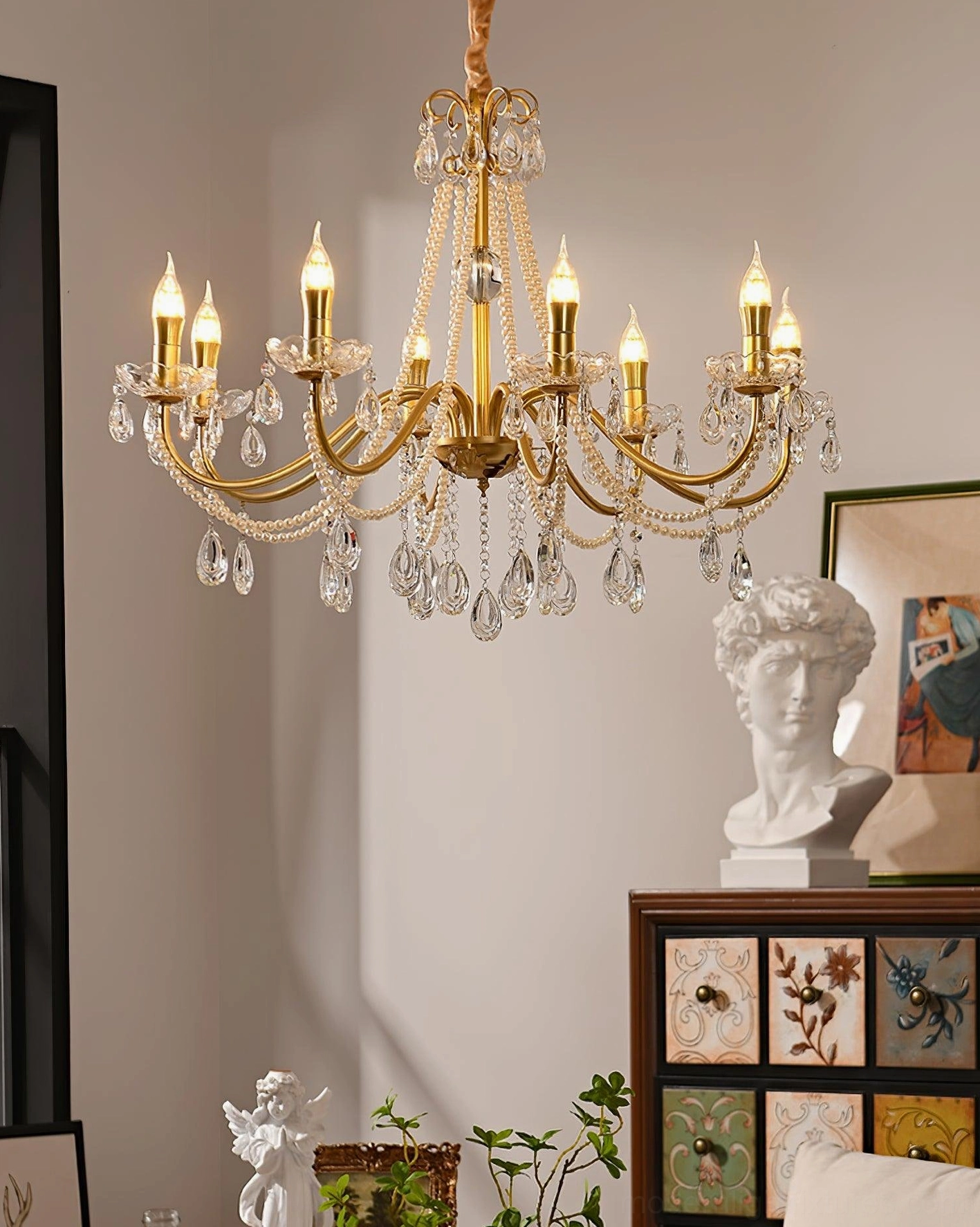 8-head gold crystal chandelier illuminated in vintage art deco living room interior design setting