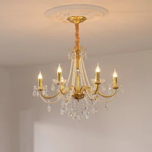 Elegant crystal chandelier installed on decorative ceiling medallion, warm lighting accent in formal dining room