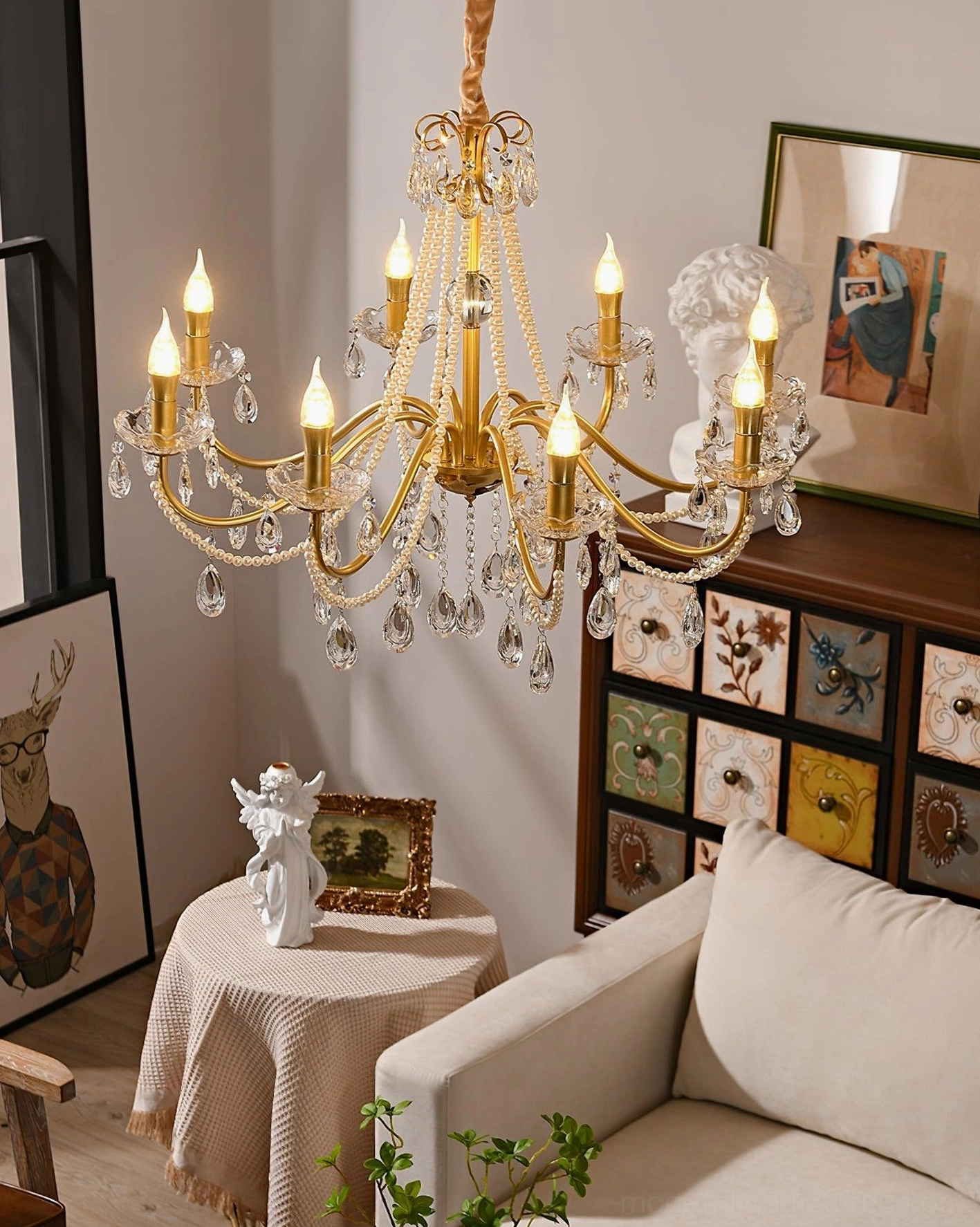 Ornate crystal chandelier with clear crystals and gold metal frame creating elegant light fixture ambiance