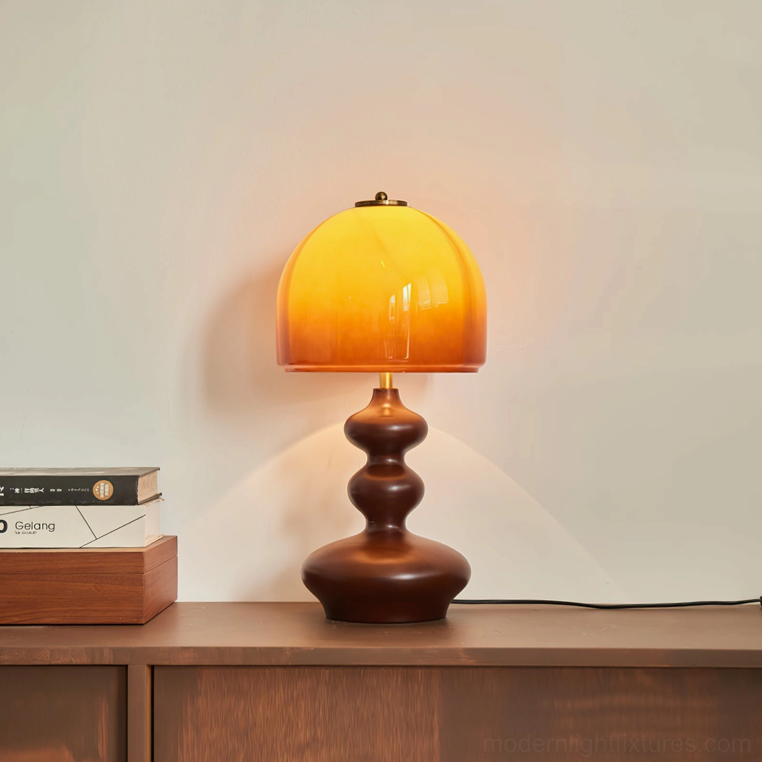 Willow table lamp front profile view, sculptural matte wood base with caramel glass dome