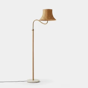 Willowen hand-woven rattan arc floor lamp with gold metal pole and white round base, front left view in minimalist studio setting