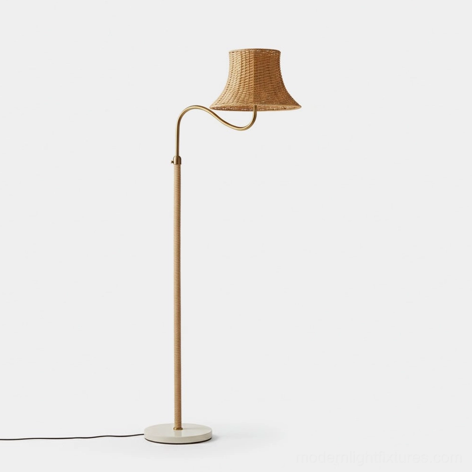 Willowen hand-woven rattan arc floor lamp with gold metal pole and white round base, front left view in minimalist studio setting