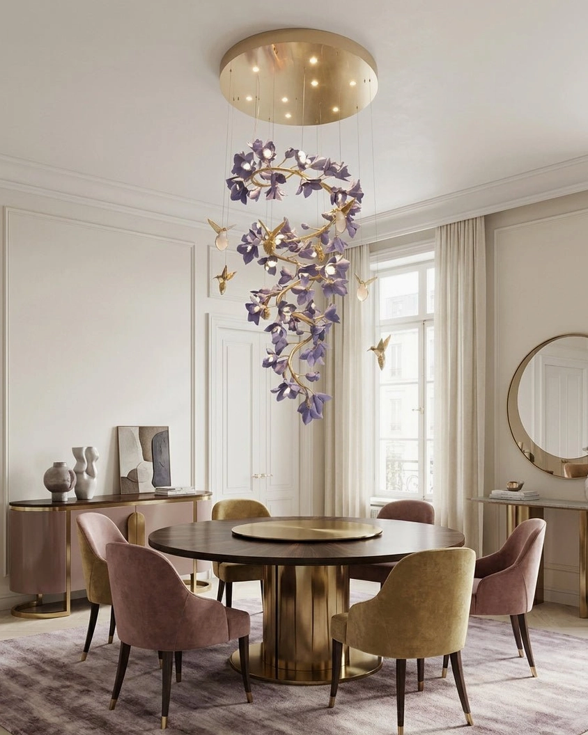 Vertical purple flower garland chandelier with gold accents above compact round dining area