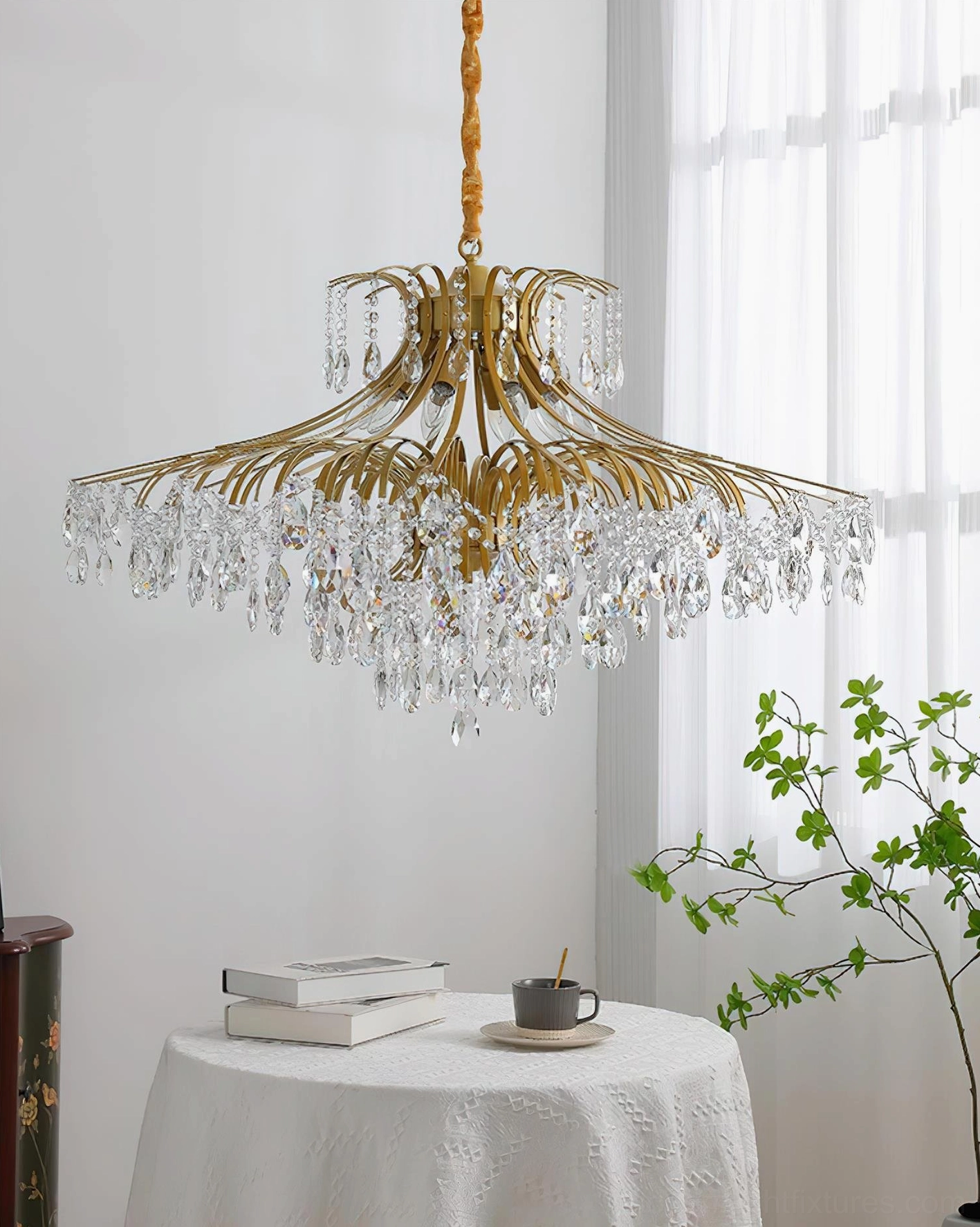Wisteria chandelier illuminated at evening showing warm gold tone light refraction through crystals