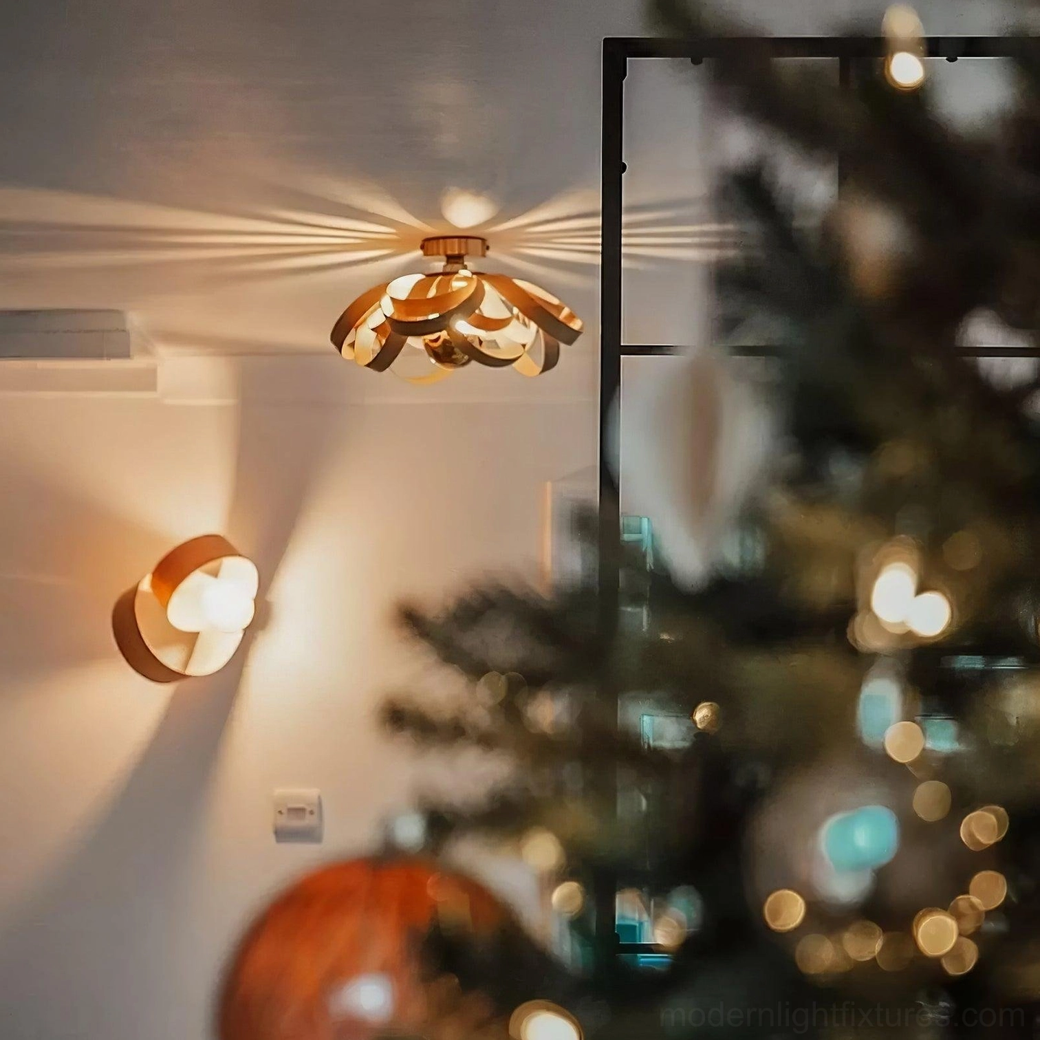Dual-tone wood petal light with matching wall sconce in festive living room setting