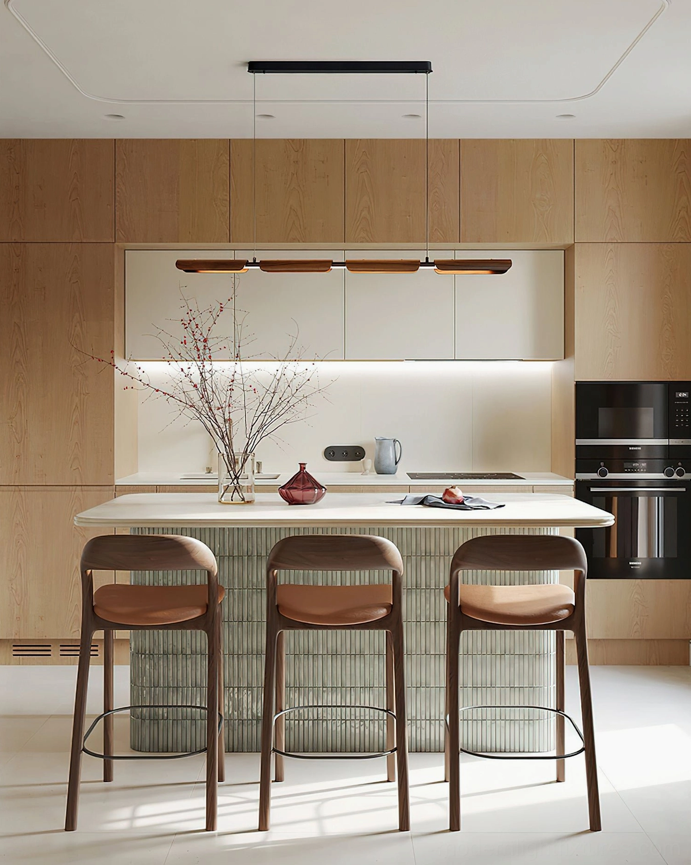 Modern wood pendant light installed in contemporary kitchen above island, warm walnut finish with black metal hardware