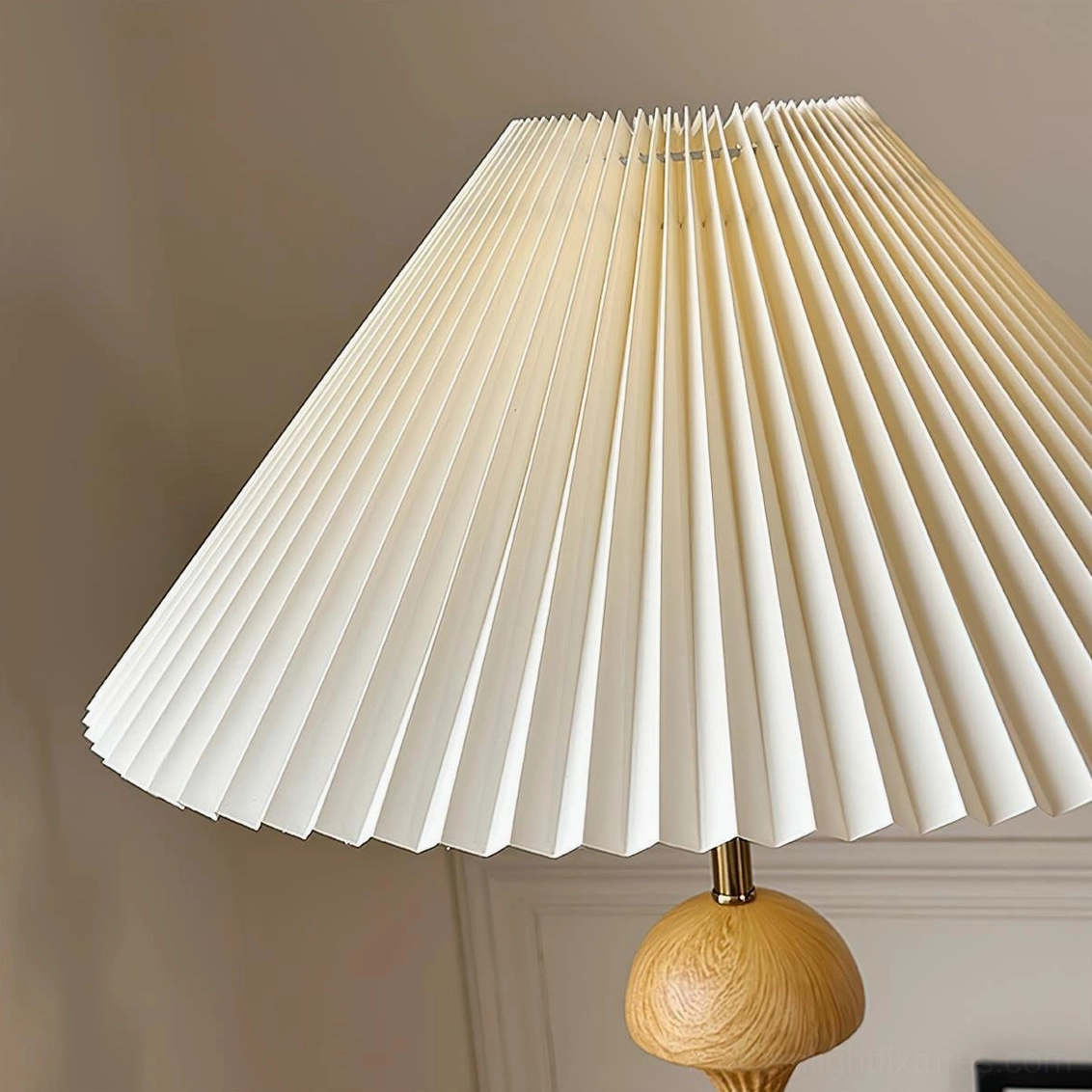 Natural wood beaded floor lamp positioned in living room corner beside armchair, demonstrating proper placement and scale in interior design