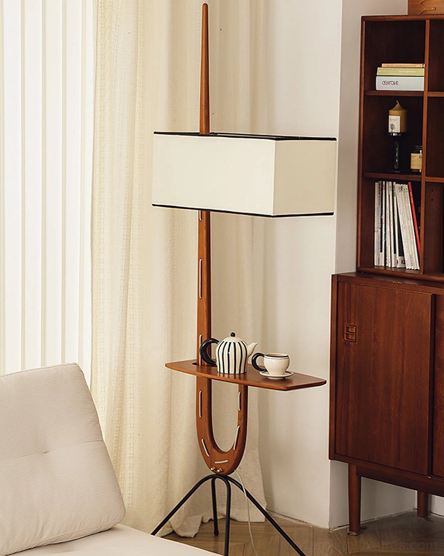 Modern wood floor lamp with integrated side table and teapot teacup set in living room bookshelf area