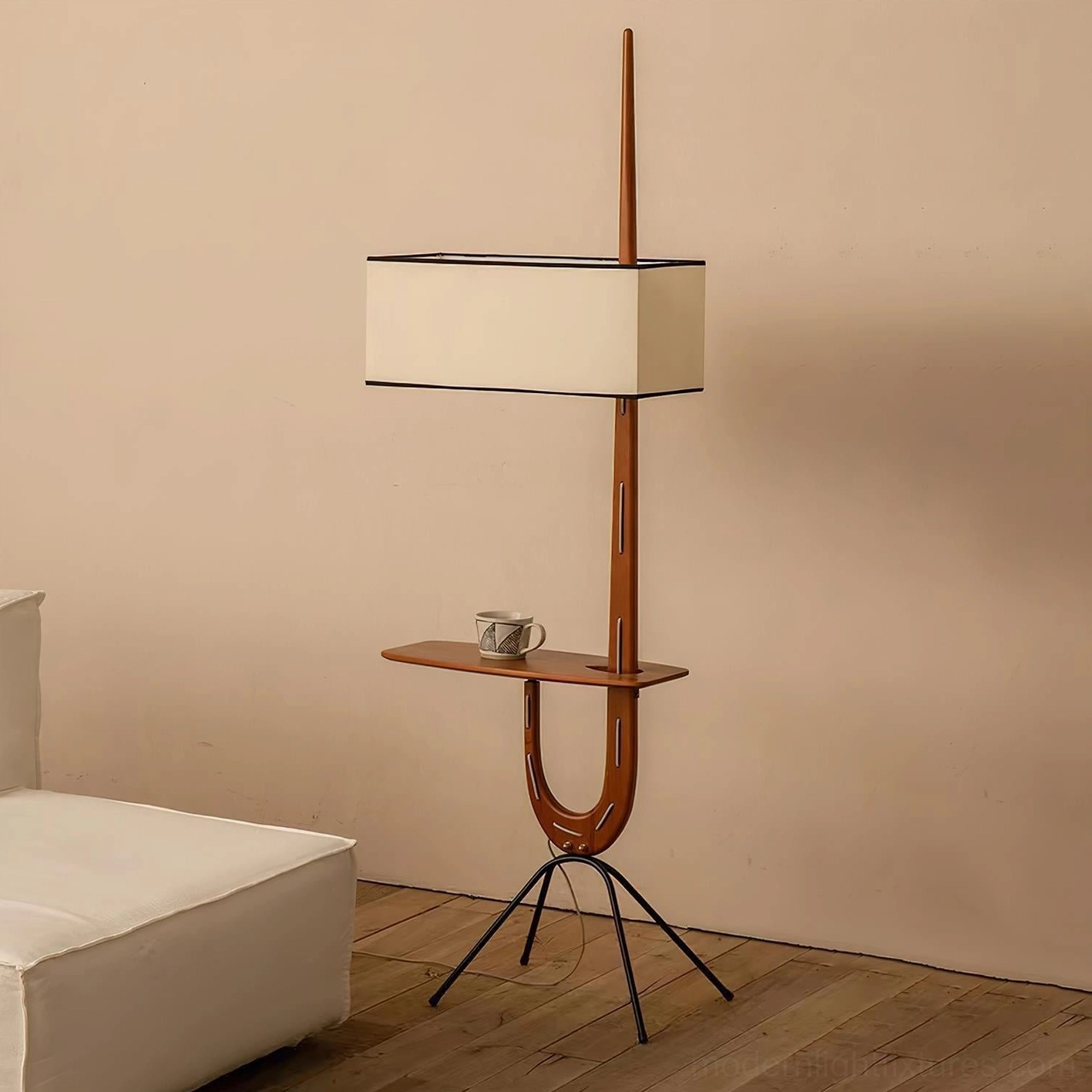 Wood floor lamp with functional side shelf holding tea cup in contemporary bedroom with daybed