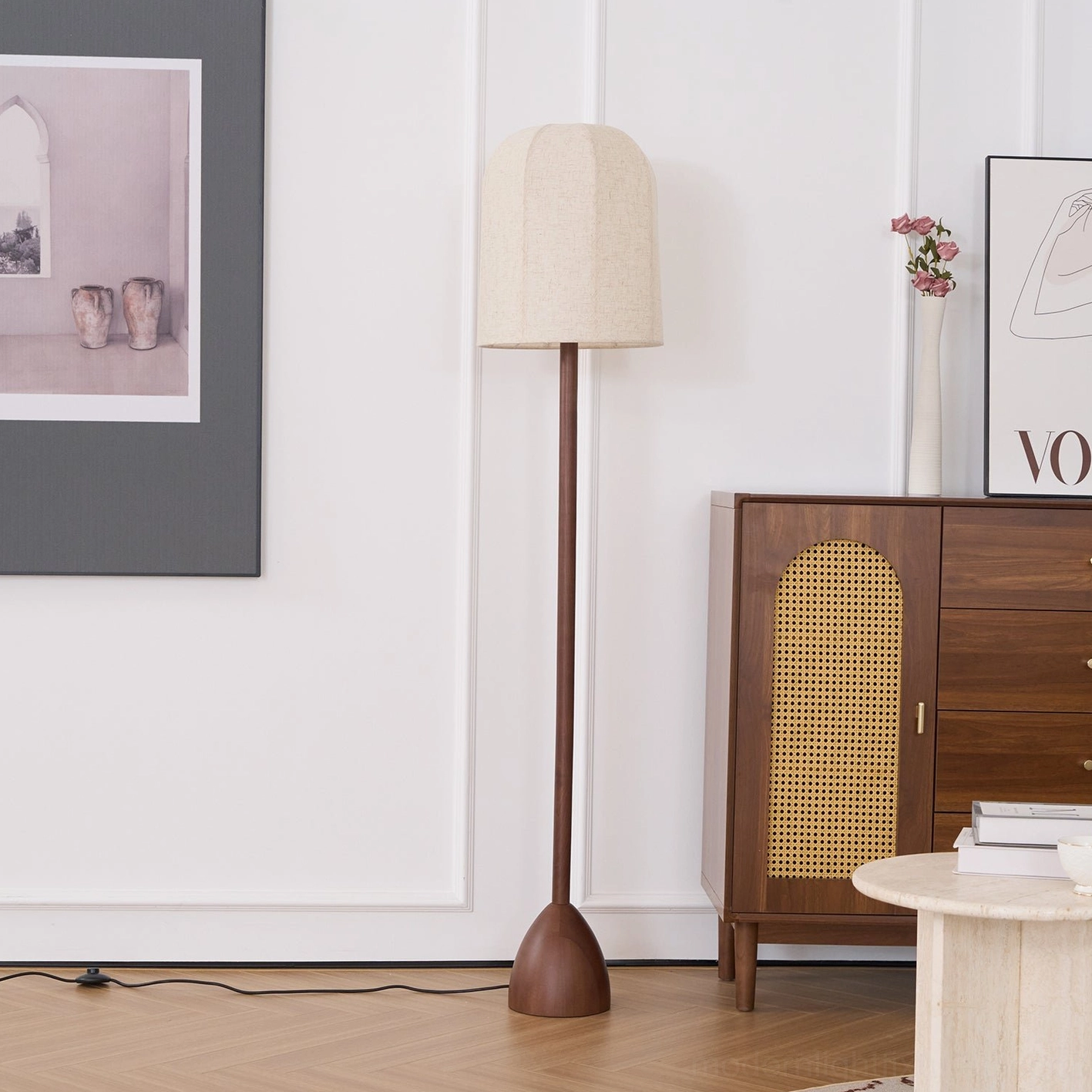 Modern wood floor lamp beside side table - tapered round base with exposed power cord and warm tone