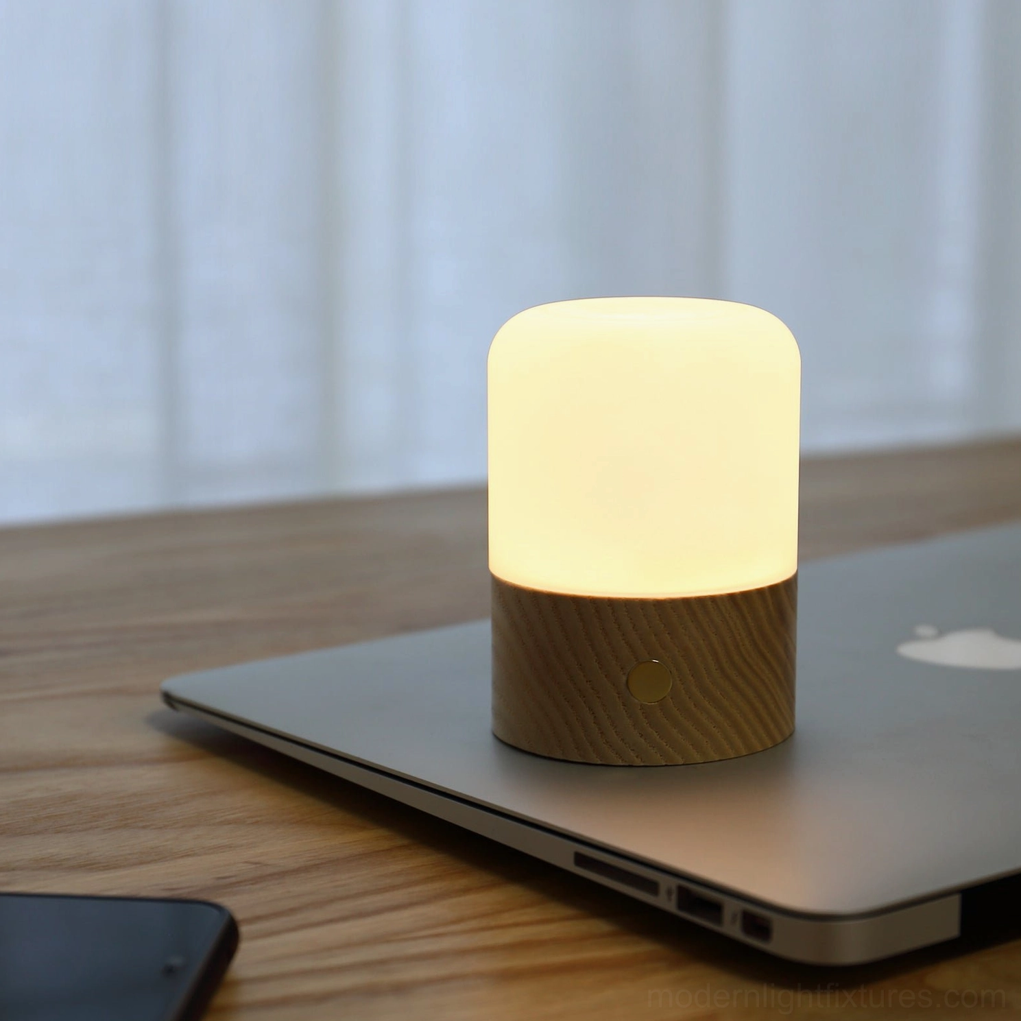 Portable wood and glass aroma diffuser table lamp with warm ambient lighting on desk workspace