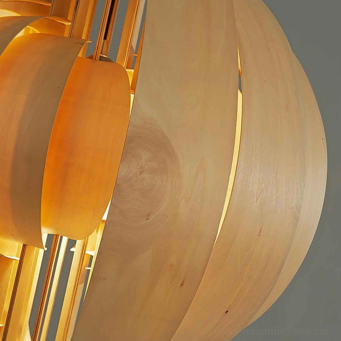 Wooden globe pendant light illuminated showing warm diffused glow through interlaced wood framework