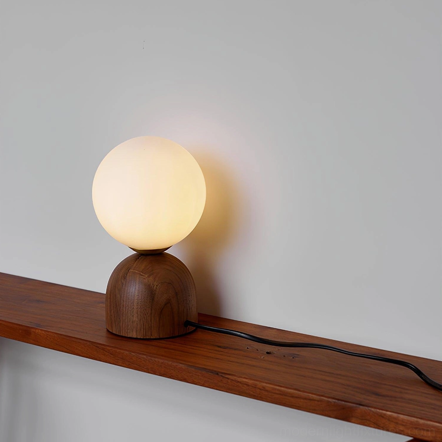 Wooden globe table lamp right side view on rustic shelf, warm home decor style