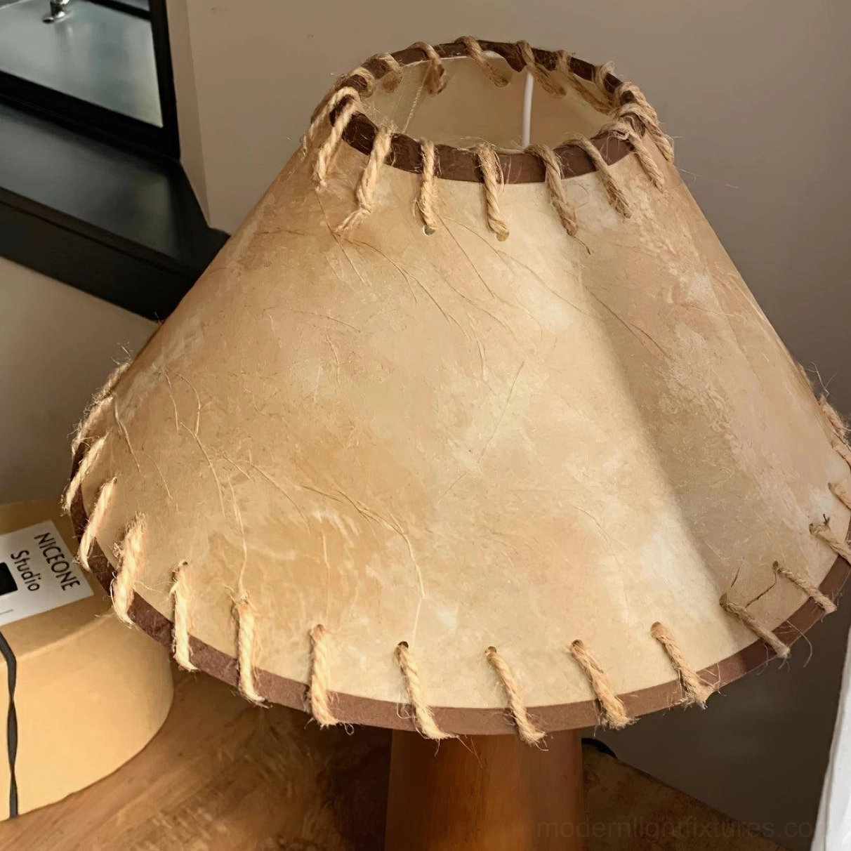 Wood base table lamp with jute shade in gallery wall setting showcasing home decor styling and lighting accent