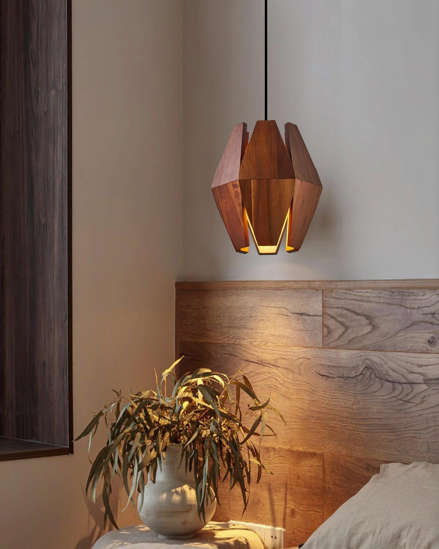 Side view of walnut wood pendant light creating ambient lighting in contemporary bedroom