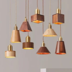 Collection of six wood pendant lights in natural and walnut finishes with brass hardware