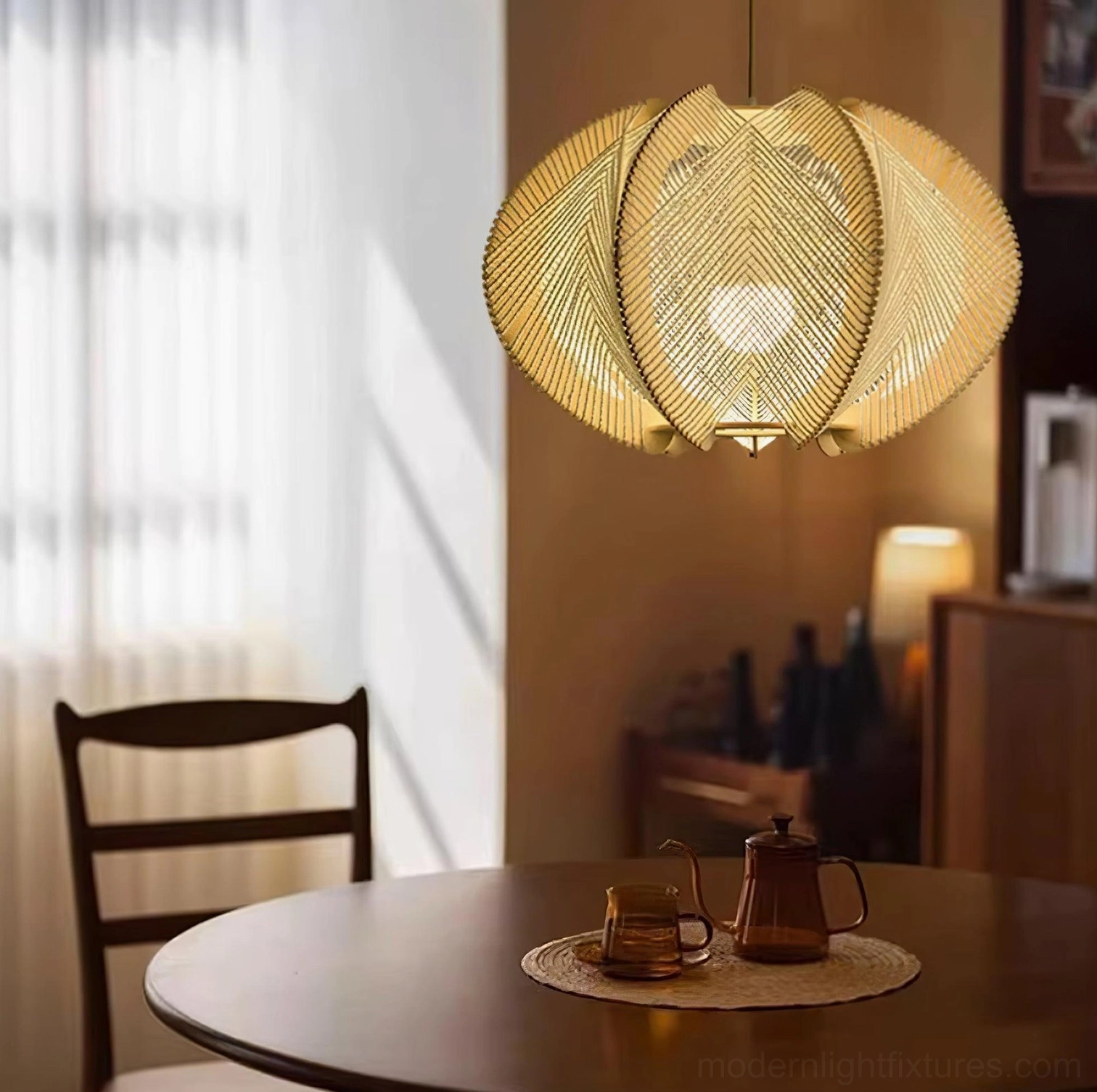 Woven wood pendant light suspended above dining table in home dining area