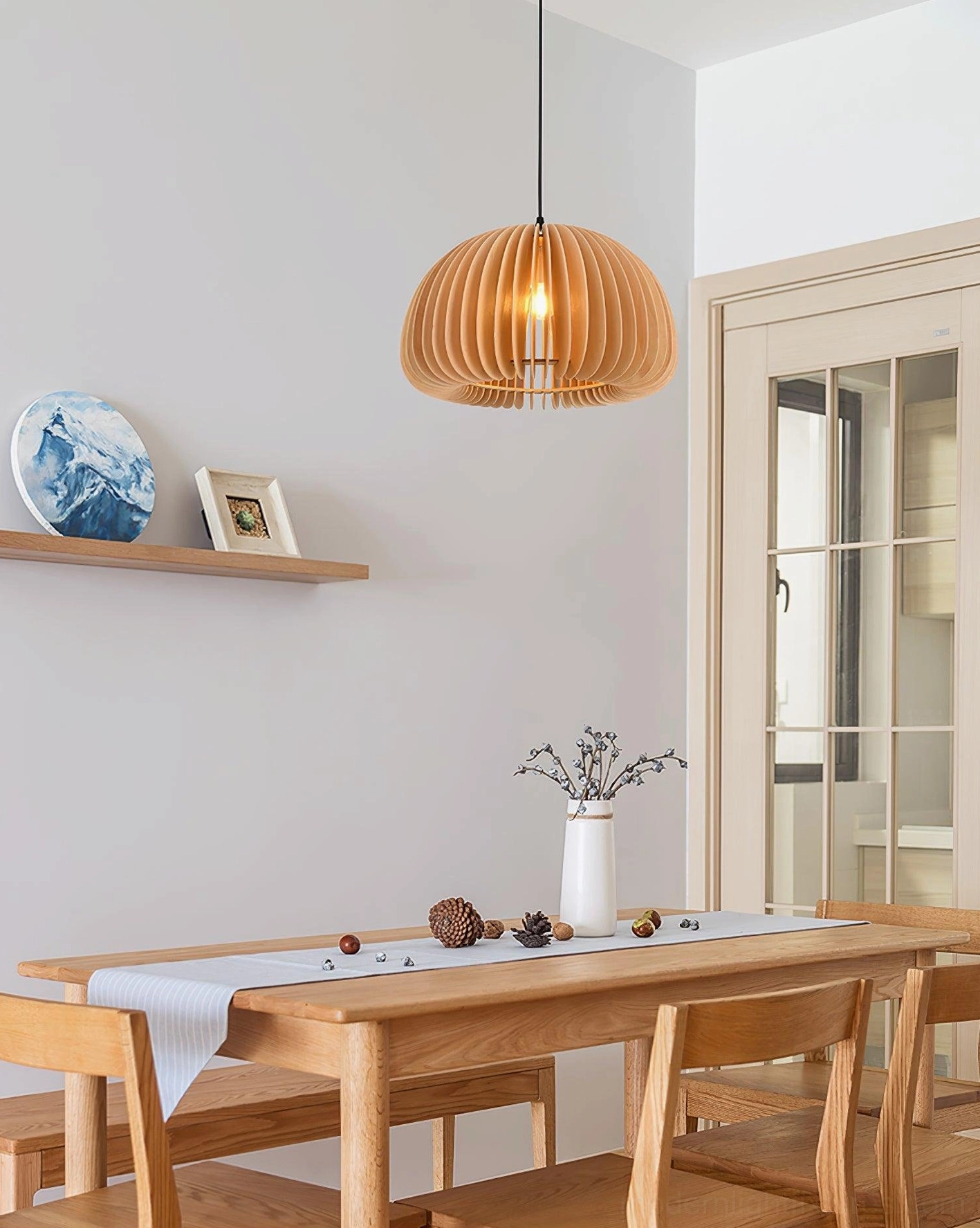 Natural wood pumpkin pendant light showing warm light diffusion through wooden slats